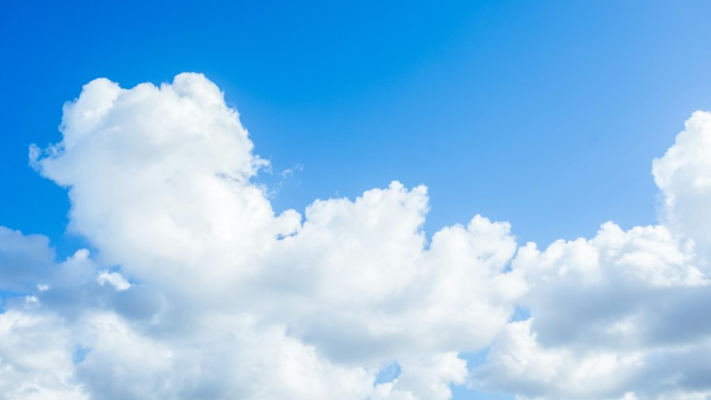 A blue sky with white fluffy clouds
